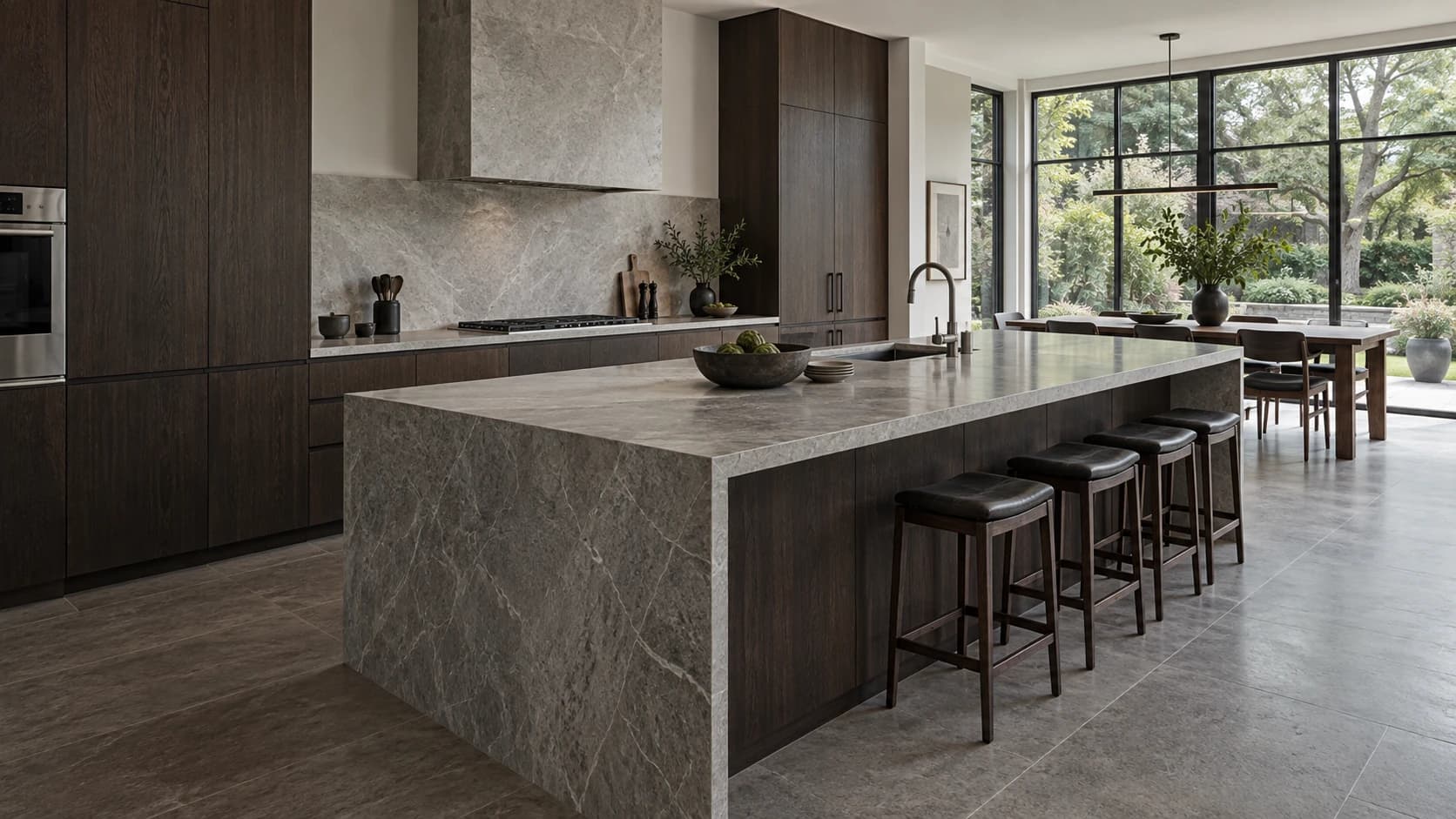 Architectural kitchen concept with oak cabinetry, a generous stone island and garden views